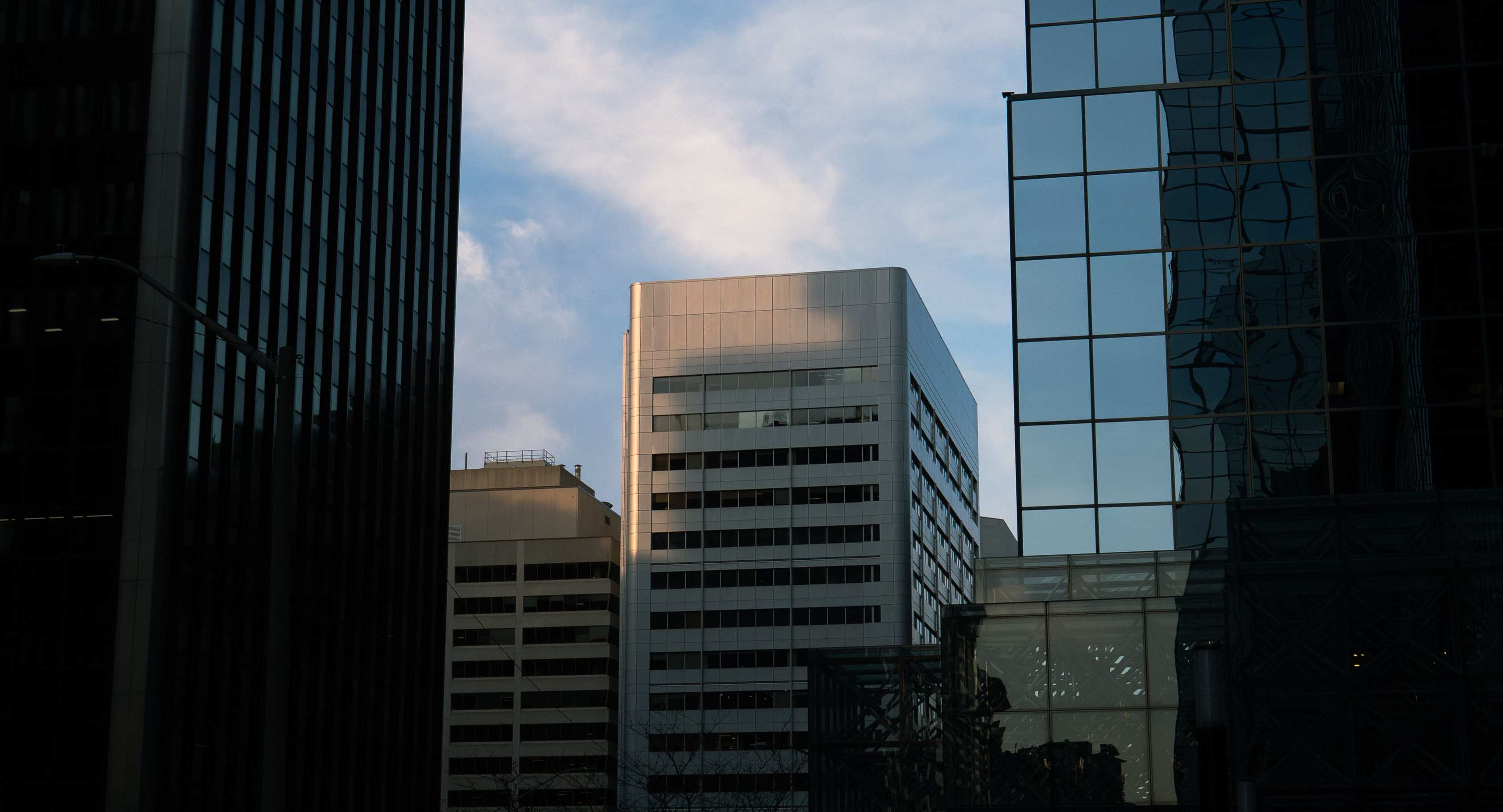 Urban street with commercial buildings and modern glass reflections