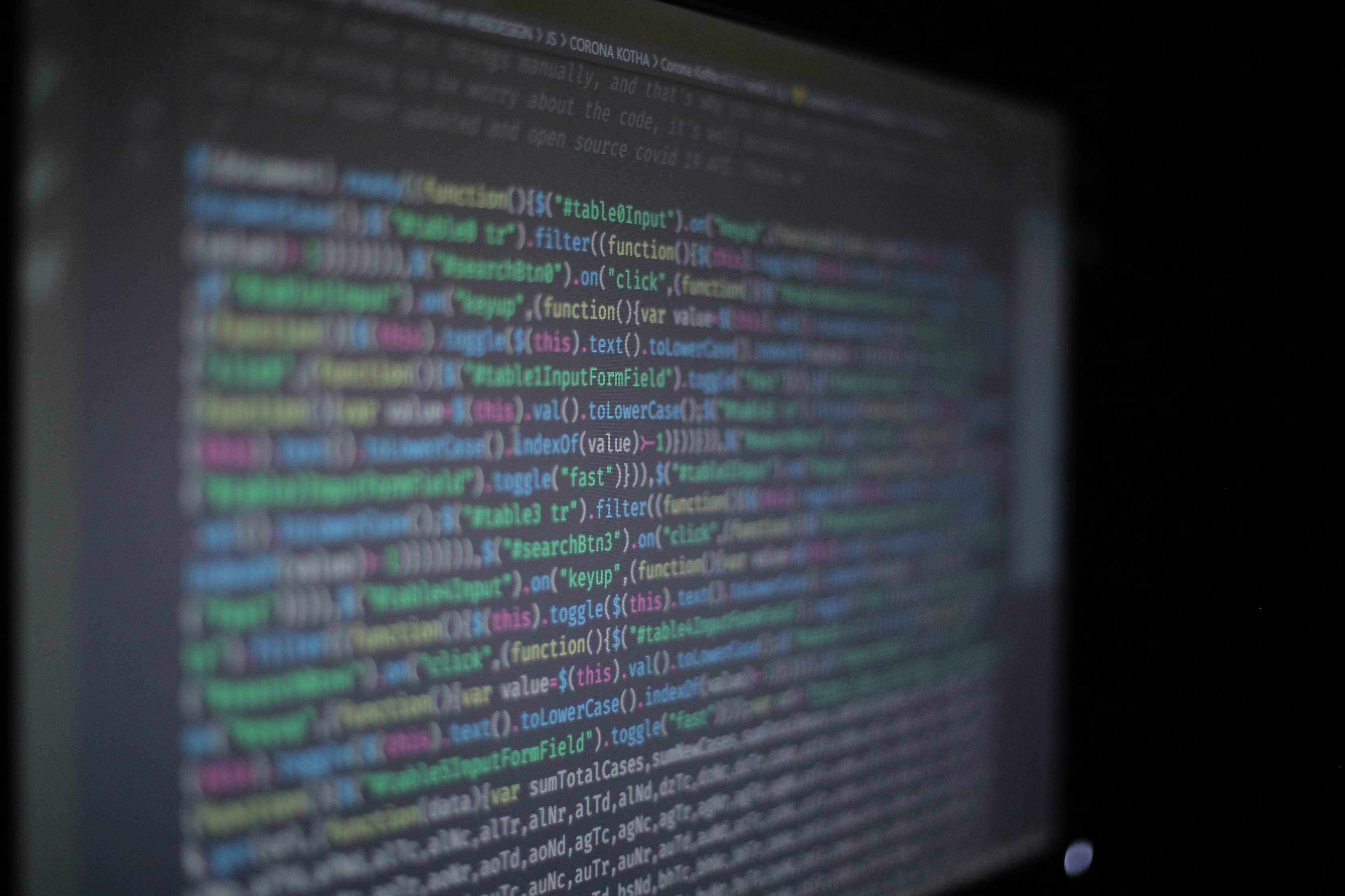 Close view of source code on a display with programming code on a monitor